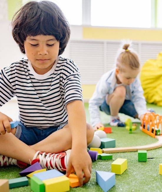 Child settling into preschool with teacher support